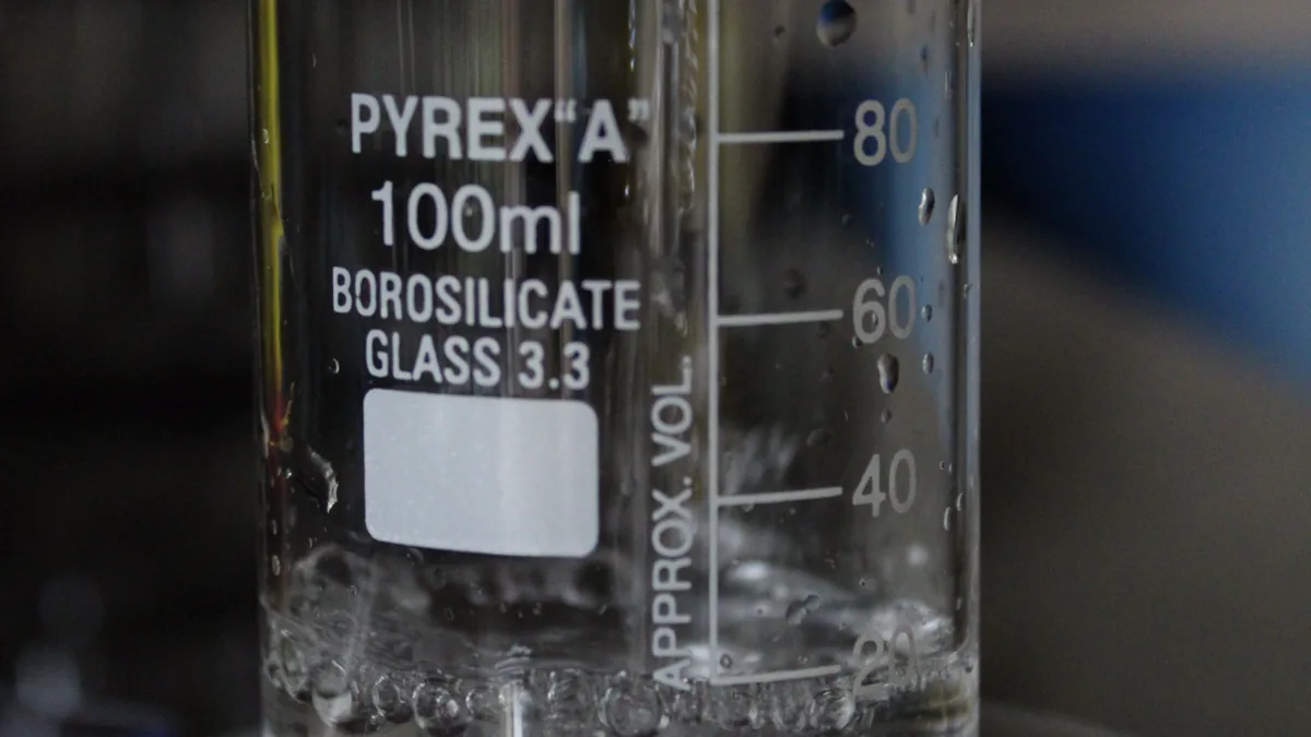 Water being poured into a laboratory beaker for testing